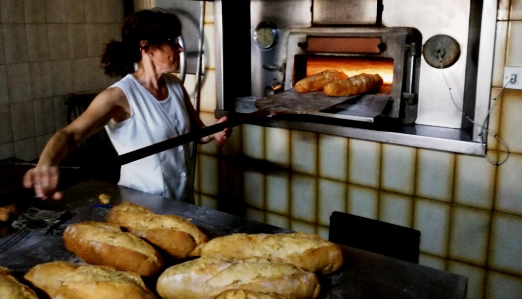 Panadero trabajando preparando horno para hacer pan fotografías e